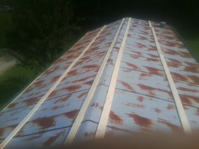 Rusted metal roof panels with new wood purlins before replacement — Storm Damage Roof Repair in Cookeville by Roofing Brothers